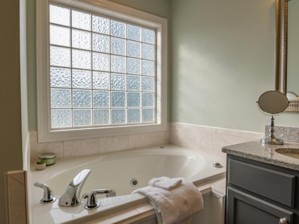 white ceramic bathtub near white ceramic bathtub